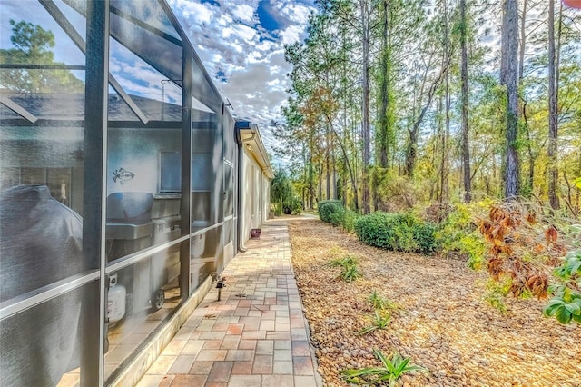 view of side of property with a lanai