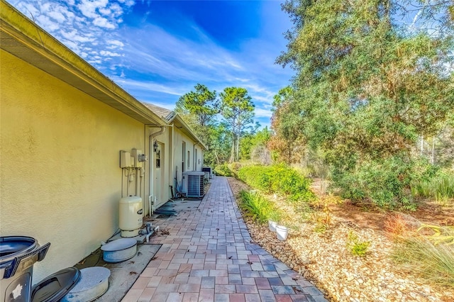 view of side of property with central AC unit