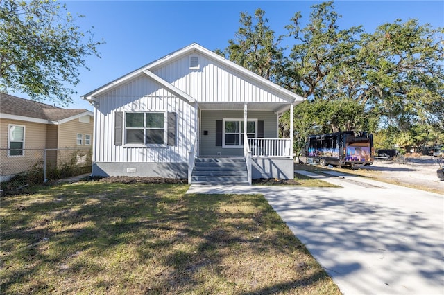 bungalow-style home featuring a porch and a front lawn