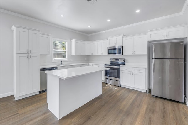 kitchen with sink, stainless steel appliances, dark hardwood / wood-style floors, a center island, and white cabinets