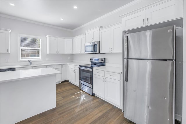 kitchen featuring white cabinetry, appliances with stainless steel finishes, and crown molding