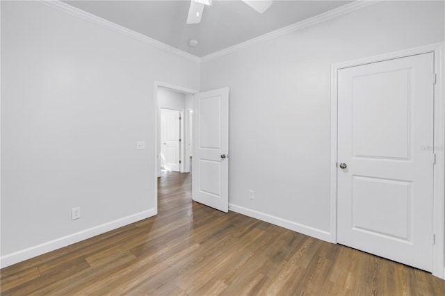 unfurnished bedroom featuring crown molding, hardwood / wood-style floors, and ceiling fan