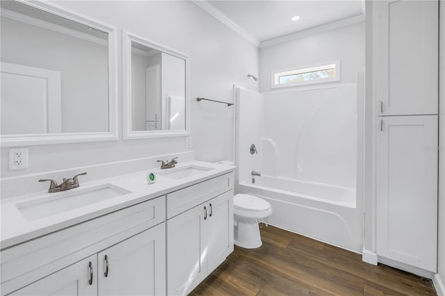 full bathroom featuring crown molding, washtub / shower combination, vanity, wood-type flooring, and toilet