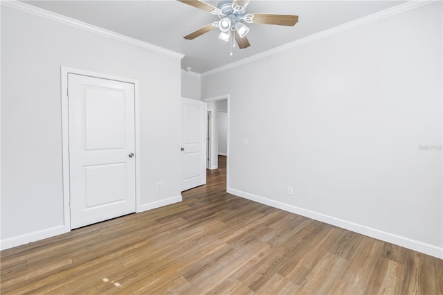 unfurnished bedroom with hardwood / wood-style floors, crown molding, and ceiling fan