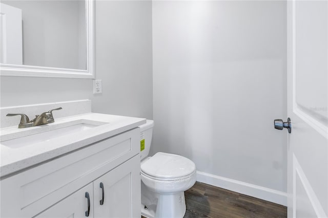 bathroom featuring vanity, hardwood / wood-style floors, and toilet