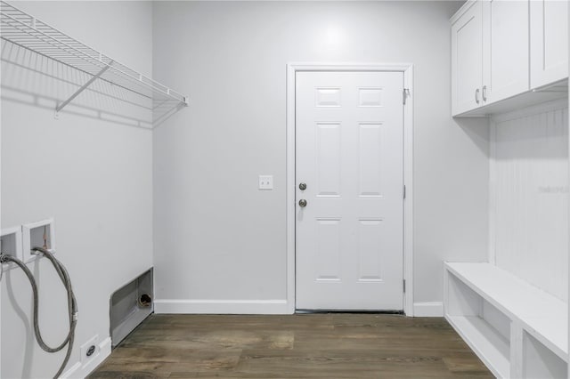 washroom with hookup for a washing machine, dark hardwood / wood-style floors, and cabinets