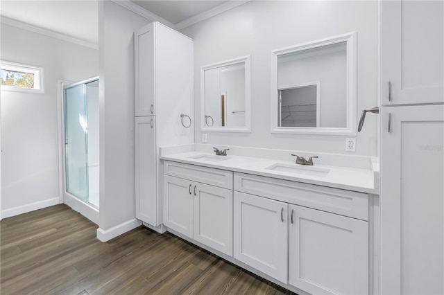 bathroom with crown molding, vanity, an enclosed shower, and hardwood / wood-style floors