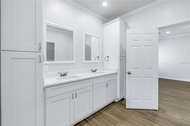 bathroom featuring crown molding, hardwood / wood-style floors, and vanity