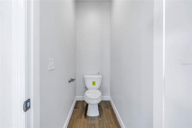 bathroom featuring hardwood / wood-style flooring and toilet