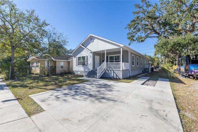 view of front of house with a front lawn and a porch