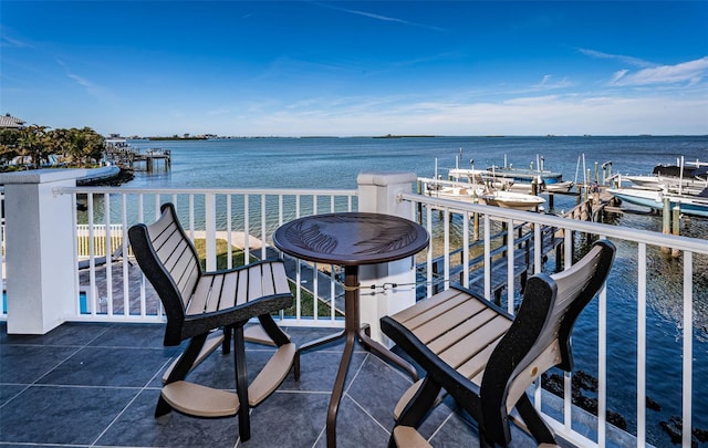 balcony featuring a boat dock and a water view