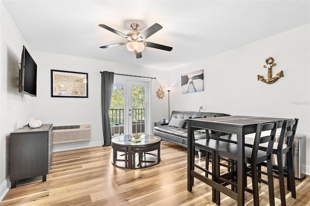 dining space featuring ceiling fan, light wood-type flooring, and french doors