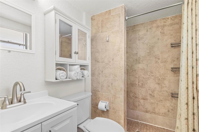 bathroom featuring curtained shower, vanity, a textured ceiling, and toilet