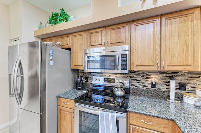 kitchen featuring backsplash, dark stone countertops, and stainless steel appliances