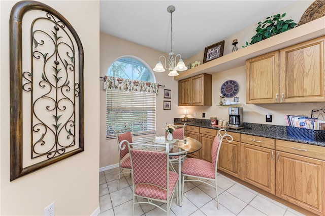 tiled dining area featuring an inviting chandelier