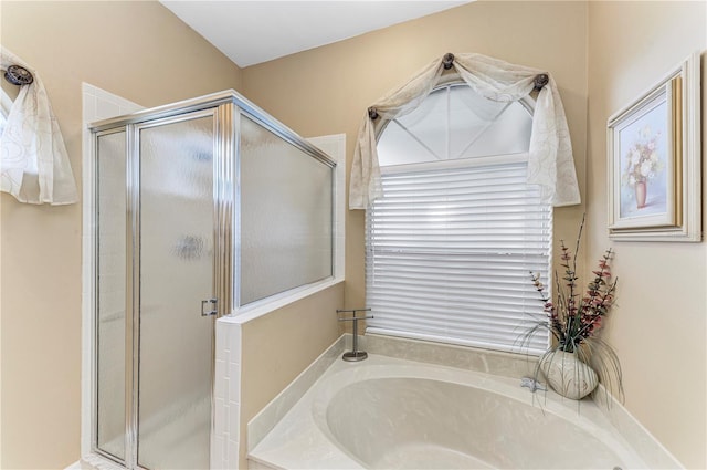 bathroom with separate shower and tub and plenty of natural light