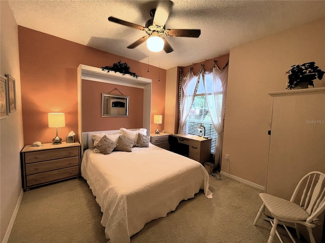 carpeted bedroom featuring ceiling fan and a textured ceiling