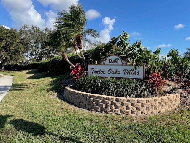 community / neighborhood sign with a lawn