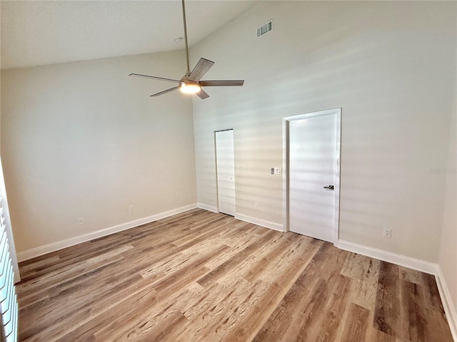 unfurnished bedroom featuring ceiling fan, wood-type flooring, and high vaulted ceiling