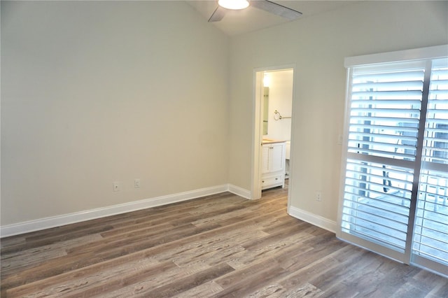 empty room featuring ceiling fan and dark wood-type flooring