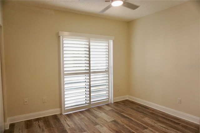 spare room featuring dark hardwood / wood-style floors and ceiling fan