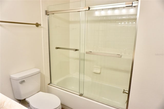 bathroom with toilet and enclosed tub / shower combo