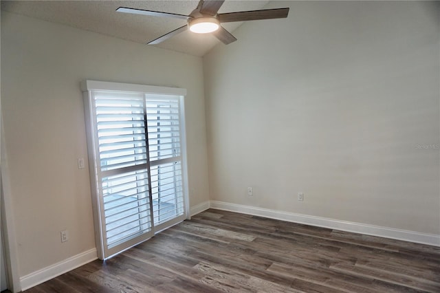 unfurnished room featuring dark hardwood / wood-style flooring, vaulted ceiling, and ceiling fan