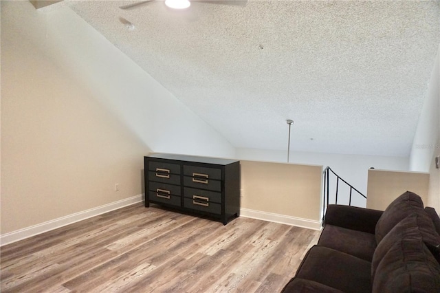 sitting room with hardwood / wood-style floors, ceiling fan, and a textured ceiling