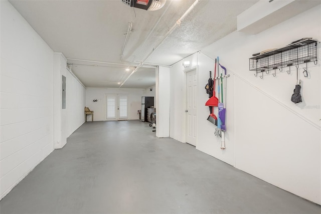 garage featuring electric panel and a garage door opener