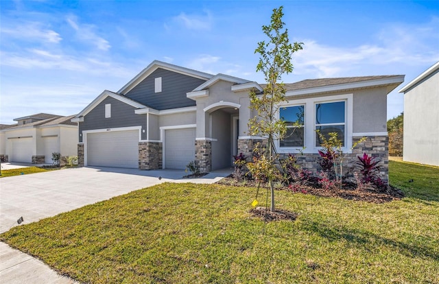 view of front of home with a front yard and a garage