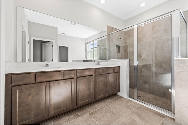 bathroom featuring vanity and a shower with shower door