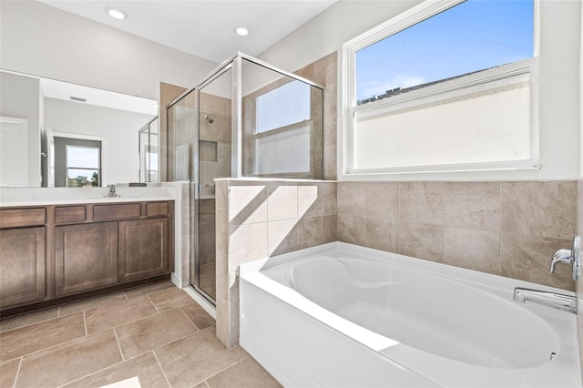 bathroom featuring vanity and plus walk in shower