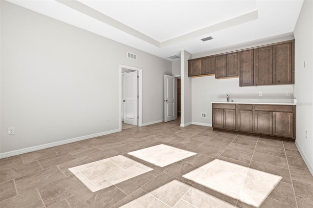 kitchen featuring dark brown cabinets and sink