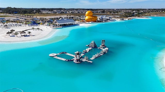 aerial view featuring a view of the beach and a water view