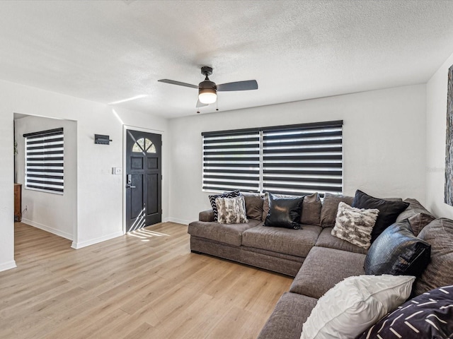 2000 57th St N, Saint Petersburg, FL 33710 - living room featuring ceiling fan, light hardwood / wood-style floors, and a textured ceiling