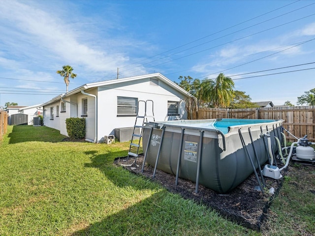 2000 57th St N, Saint Petersburg, FL 33710 - back of property with a fenced in pool, a lawn, and cooling unit