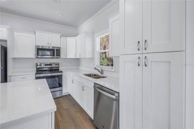 kitchen with sink, white cabinetry, crown molding, stainless steel appliances, and light stone countertops