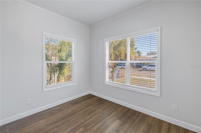 empty room with crown molding and dark wood-type flooring