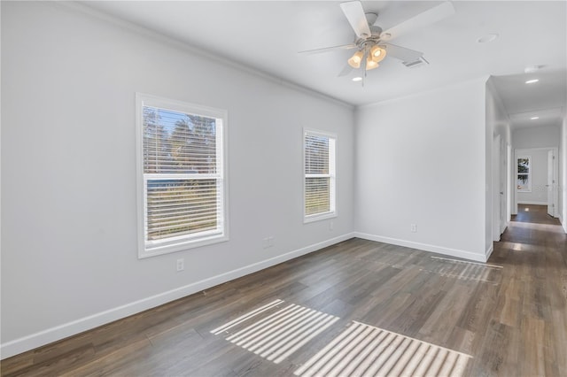 spare room with dark wood-type flooring, ornamental molding, and ceiling fan