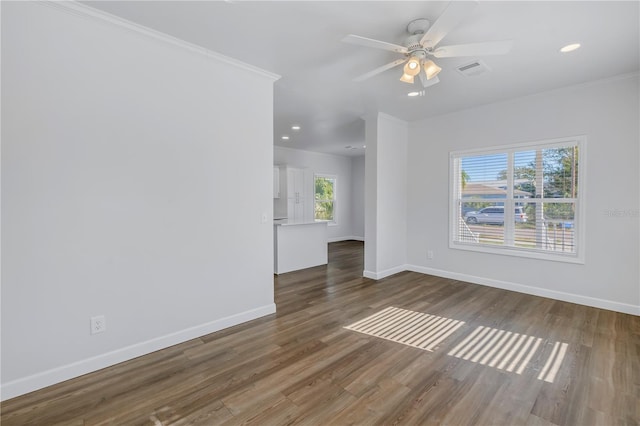 unfurnished room with dark wood-type flooring, ornamental molding, and ceiling fan