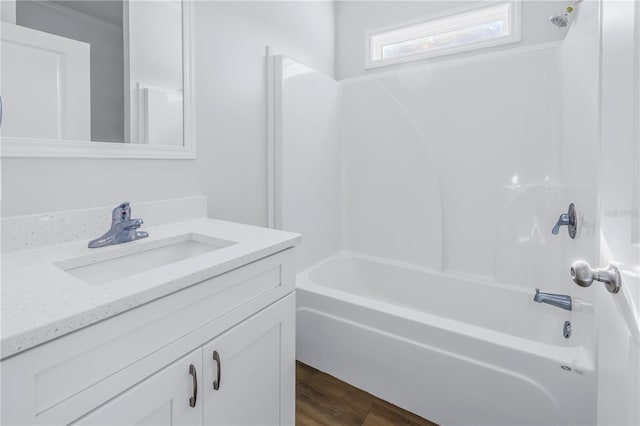 bathroom with vanity, hardwood / wood-style floors, and shower / bathtub combination