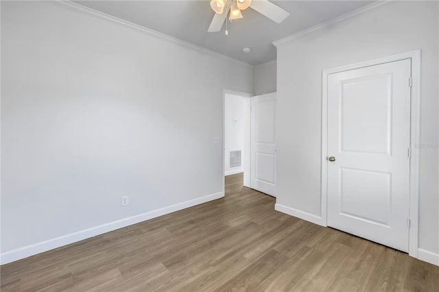 unfurnished bedroom with ornamental molding, ceiling fan, and light hardwood / wood-style flooring