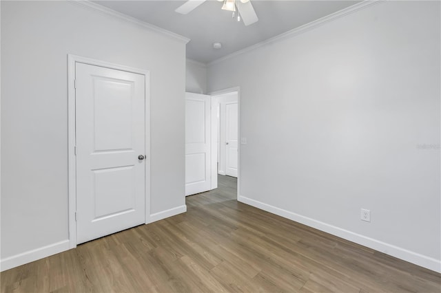 unfurnished bedroom with wood-type flooring, ornamental molding, and ceiling fan