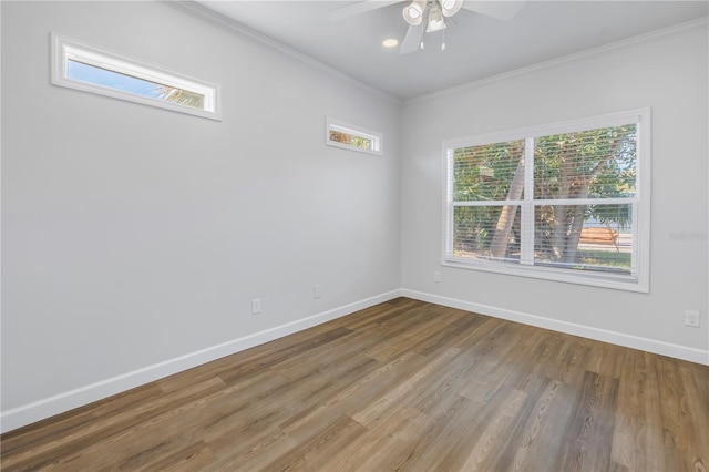 spare room featuring hardwood / wood-style floors, ornamental molding, and ceiling fan