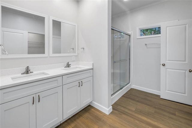 bathroom with vanity, hardwood / wood-style flooring, and walk in shower