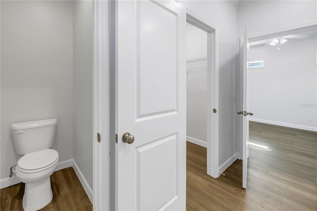 bathroom with hardwood / wood-style floors and toilet