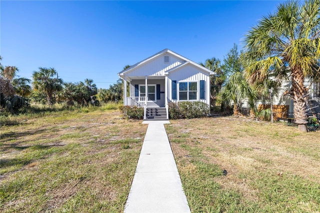 view of front of home with a porch and a front yard