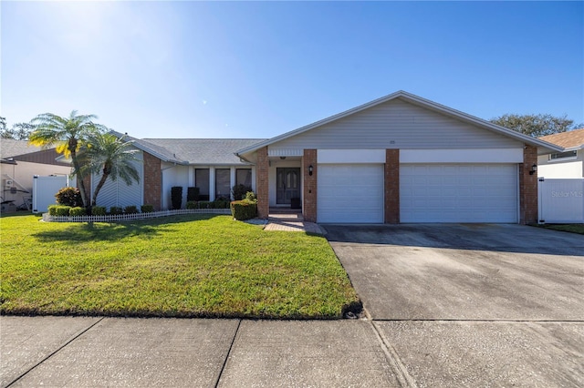 ranch-style house featuring a front yard and a garage