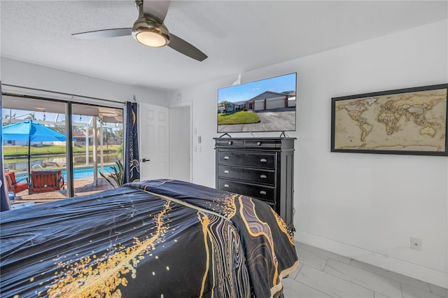 bedroom featuring access to exterior, ceiling fan, and a textured ceiling