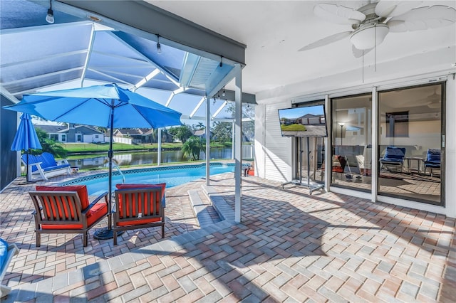 view of swimming pool with a patio area, ceiling fan, and a lanai